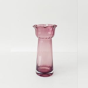 Small corrugated purple glass vase with a scalloped, folded edge.